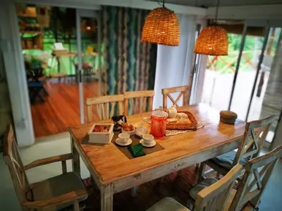 a wooden table with two chairs and a dining room at LOFT DE MONTAÑA -LaS RABONAS - PISCINA EXCLUSIVA in Las Rabonas
