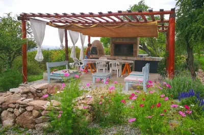 a patio with a table and chairs and a fireplace at LOFT DE MONTAÑA -LaS RABONAS - PISCINA EXCLUSIVA in Las Rabonas