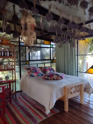 a bedroom with a bed in a room with windows at LOFT DE MONTAÑA -LaS RABONAS - PISCINA EXCLUSIVA in Las Rabonas