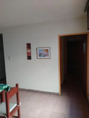 a room with a white wall with two pictures on it at Ser Uno in Cordoba