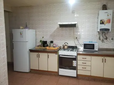 a kitchen with a refrigerator and a stove and a microwave at Ser Uno in Cordoba
