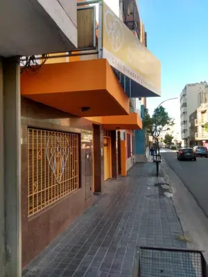 a sidewalk in front of a building with a gate at Ser Uno in Cordoba