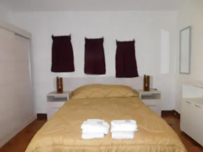 a bedroom with a bed with two towels on it at Filipao Aparts in Santa Rosa de Calamuchita
