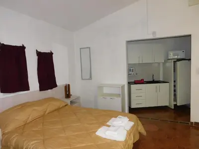 a bedroom with a bed with towels on it at Filipao Aparts in Santa Rosa de Calamuchita