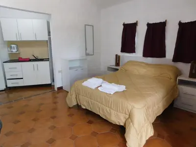 a bedroom with a bed with two towels on it at Filipao Aparts in Santa Rosa de Calamuchita