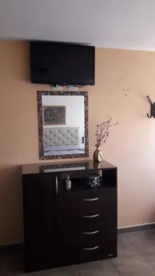 a entertainment center with a television on a wall at Maganal in Villa Carlos Paz