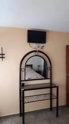 a bedroom with a iron bed with a wall at Maganal in Villa Carlos Paz