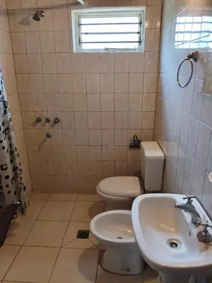 a bathroom with a toilet and a sink at CABAÑAS CAMPO CHICO in Trapiche