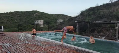 a group of people in a swimming pool at CABAÑAS CAMPO CHICO in Trapiche