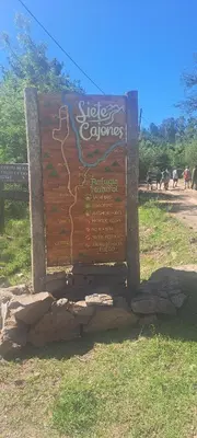 a sign for a zoo with animals in the background at CABAÑAS CAMPO CHICO in Trapiche