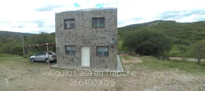 a stone house with a car parked next to it at CABAÑAS CAMPO CHICO in Trapiche