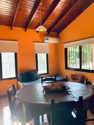 a dining room with a table with a bowl of fruit on it at Cabañas Samarana in Carpintería