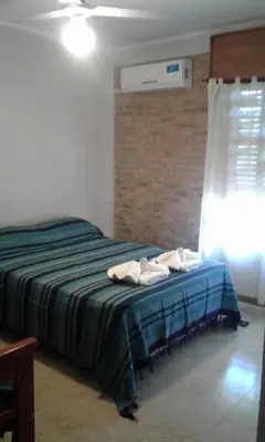 a bedroom with a bed with towels on it at Principado Sierras Hotel in Mina Clavero