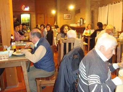 a group of people sitting at tables in a restaurant at Principado Sierras Hotel in Mina Clavero
