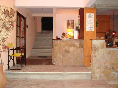 a entrance to a building with a stone wall at Principado Sierras Hotel in Mina Clavero