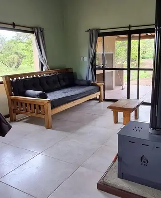 a living room with a couch and a table at Cabañas Altos de San Blas in San Javier