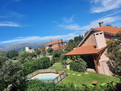 a house with a swimming pool in the yard at Casa Etor in Merlo