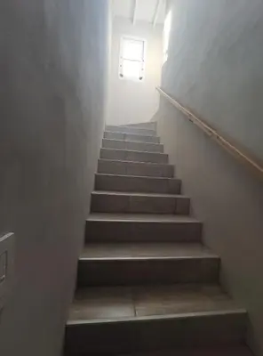 a stairway with a stair case with a window at Casa Etor in Merlo