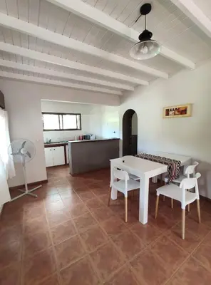 a living room with a white table and chairs at Casa Etor in Merlo