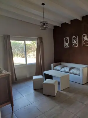 a living room with a couch and a table at Casa Etor in Merlo