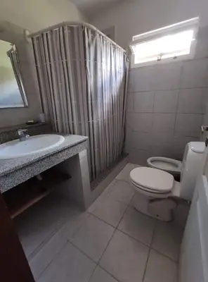 a bathroom with a toilet and a sink and a shower at Casa Etor in Merlo