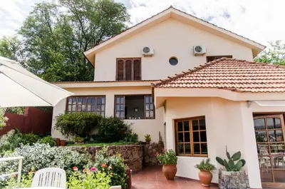 a house with a tile roof at del Buen Ayre in Villa Carlos Paz