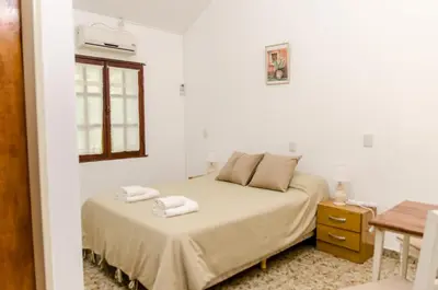 a bedroom with a bed with two towels on it at del Buen Ayre in Villa Carlos Paz