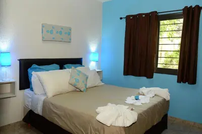 a bedroom with a bed with towels on it at Complejo Los Cipreses in Villa Carlos Paz