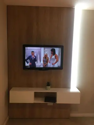 a flat screen tv sitting on a wall at Apart Ribera, Rio Cuarto in Río Cuarto