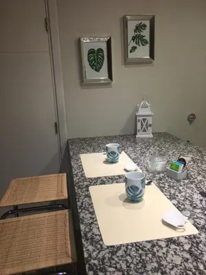 a kitchen counter with two cups on top of it at Apart Ribera, Rio Cuarto in Río Cuarto