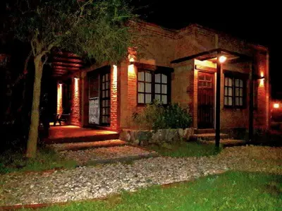 a brick house at night with lights on it at Altos de San Blas in San Javier