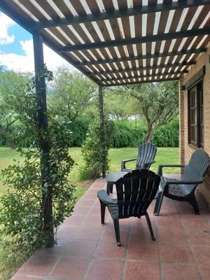 two chairs on a patio under a wooden pergola at Altos de San Blas in San Javier