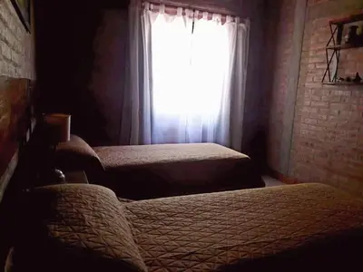 a bedroom with two beds and a window at Altos de San Blas in San Javier