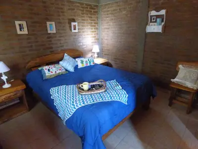 a bedroom with a blue bed with a tray on it at PIEDRALAGO CABAÑAS Y TURISMO in Villa Carlos Paz