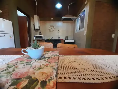 a table with a coffee cup on top of it at PIEDRALAGO CABAÑAS Y TURISMO in Villa Carlos Paz
