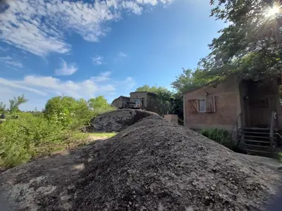 a large pile of dirt in front of a building at PIEDRALAGO CABAÑAS Y TURISMO in Villa Carlos Paz