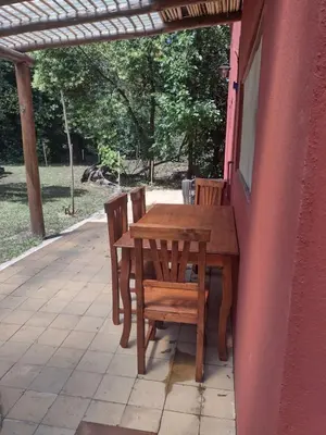 a wooden table and chairs on a patio at El Manantial in La Población