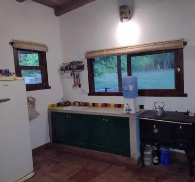 a kitchen with green cabinets and a sink and a window at El Manantial in La Población