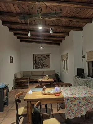 a living room with a table and a couch at El Manantial in La Población