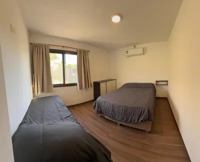 a bedroom with two beds and a window at AIRES DEL LAGO in Villa Carlos Paz