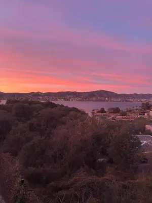 a view of a body of water at sunset at AIRES DEL LAGO in Villa Carlos Paz