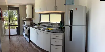 a kitchen with a refrigerator and a sink at AIRES DEL LAGO in Villa Carlos Paz
