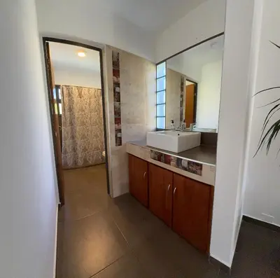 a bathroom with a sink and a mirror at AIRES DEL LAGO in Villa Carlos Paz