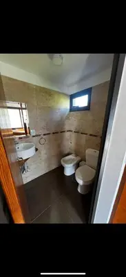a bathroom with two toilets and a sink at AIRES DEL LAGO in Villa Carlos Paz