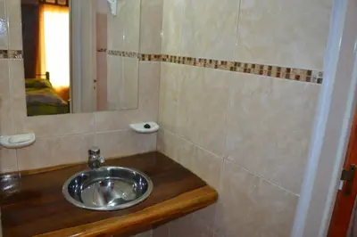 a bathroom with a sink and a mirror at Aiken Cabañas in Villa Cura Brochero