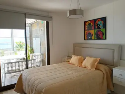 a bedroom with a large bed and a balcony at TERRAZAS DE LA COMARCA in La Cuesta