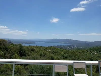 two chairs on a balcony with a view of a lake at TERRAZAS DE LA COMARCA in La Cuesta
