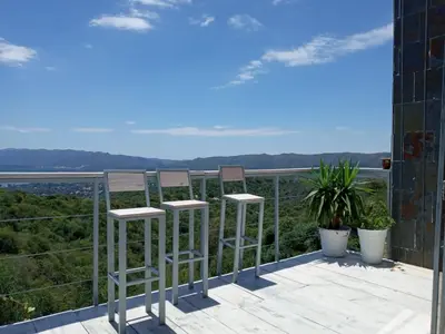 a pair of stools on a balcony with a view at TERRAZAS DE LA COMARCA in La Cuesta