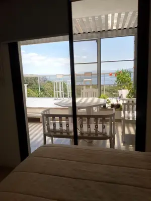 a balcony with a table and a view of the ocean at TERRAZAS DE LA COMARCA in La Cuesta