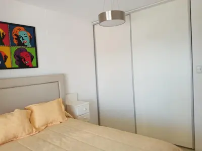 a bedroom with a bed and a painting on the wall at TERRAZAS DE LA COMARCA in La Cuesta